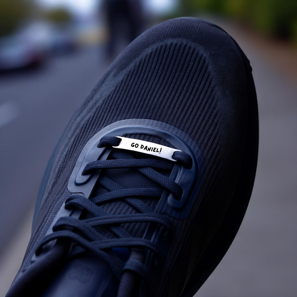 Black sneaker with a visible brand tag on a blurred street background