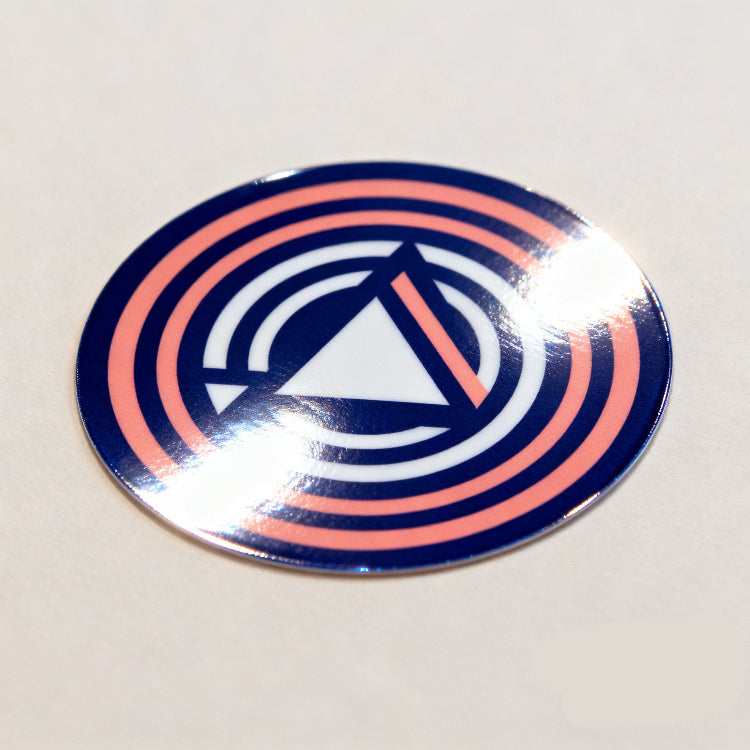 Circular sticker with a blue and pink design on a white background