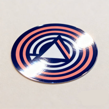 Circular sticker with a blue and pink design on a white background