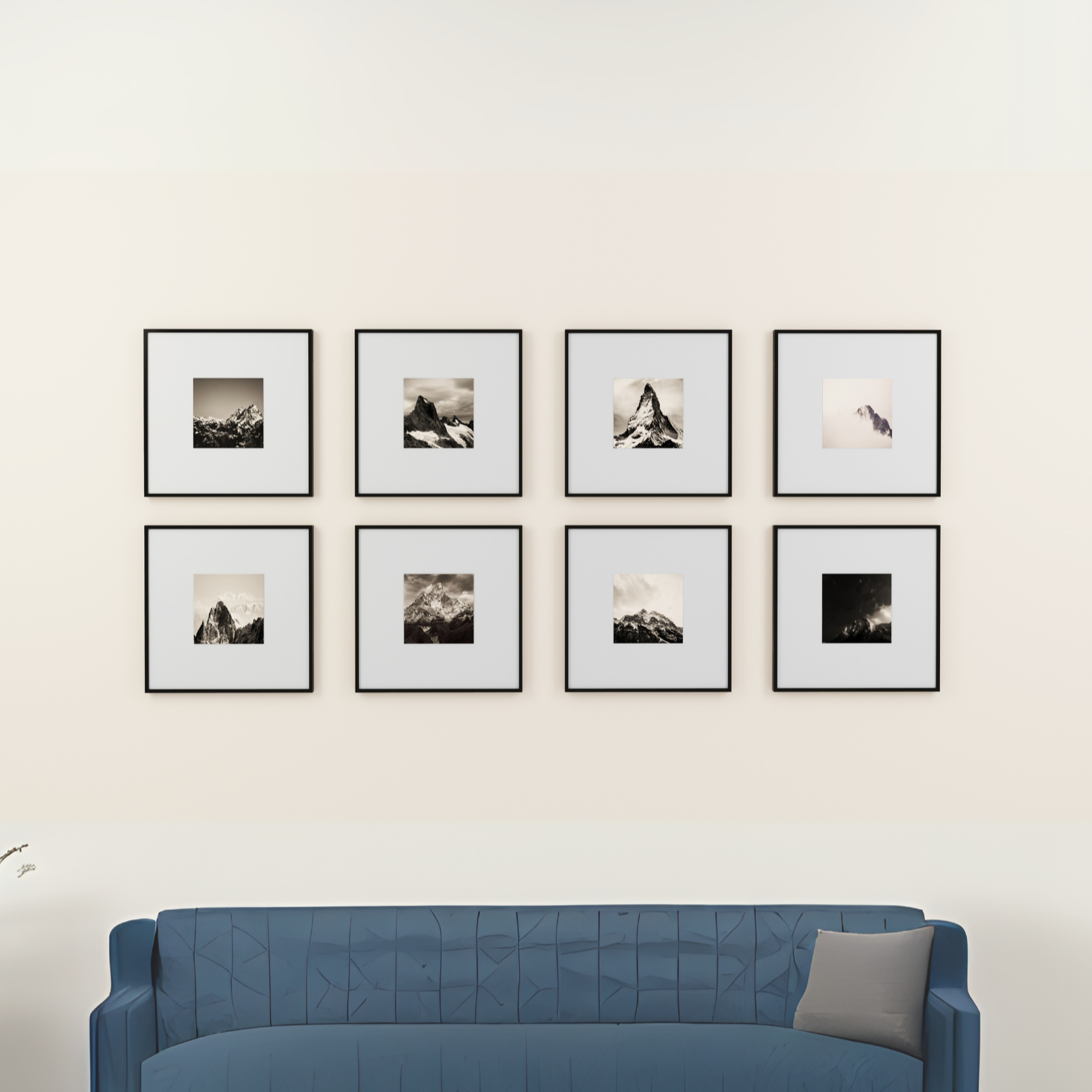 Blue sofa in front of a wall with eight framed pictures