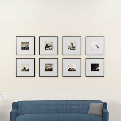 Blue sofa in front of a wall with eight framed pictures